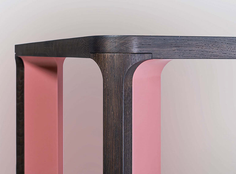 Detail of the leg in two sections, in pink lacquer and dark oak